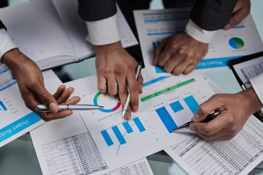 close-up. business colleagues look at the graph on the table from above