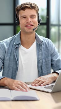 man, call center and web support communication at a computer in a office