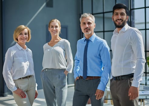 Business people stand with each other in front of a modern office