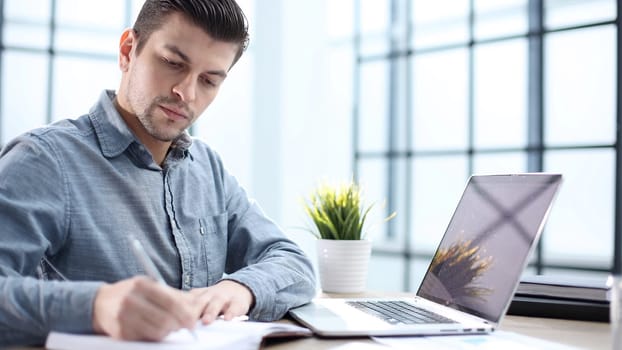 A male office worker records a report in close-up.
