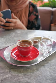 a cup of turkish coffee on table .