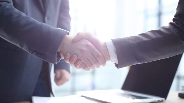 Businessmen shake hands after a successful deal.