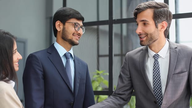 Man shaking hands with woman finishing meeting or signing contract or greeting new employee.