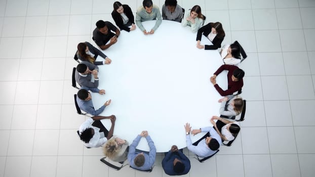 Round table top view. Business people sitting meeting corporate workspace brainstorming working team