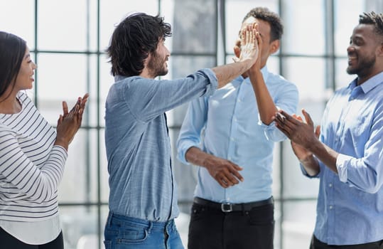 Business professionals in a meeting, collaborating, communicating, and displaying positive teamwork.