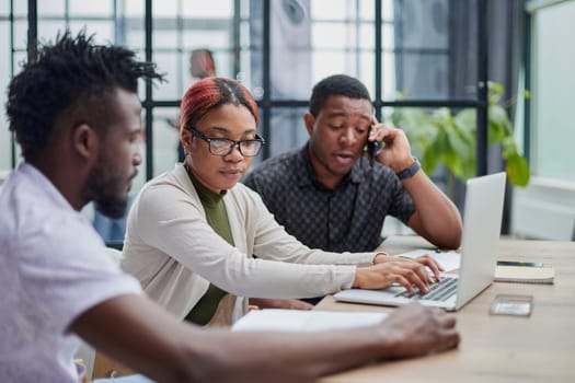 Young, motivated and experienced employees are brainstorming in the conference room.