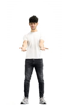 A man, on a white background, in full height, spreads his arms.