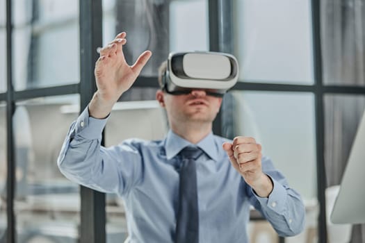 young man testing VR glasses or goggles sitting in the office room