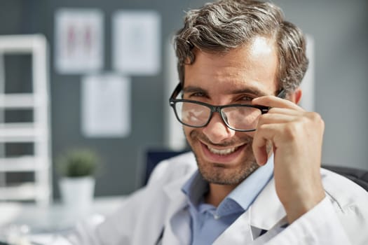 Portrait of happy arabic doctor posing at clinic