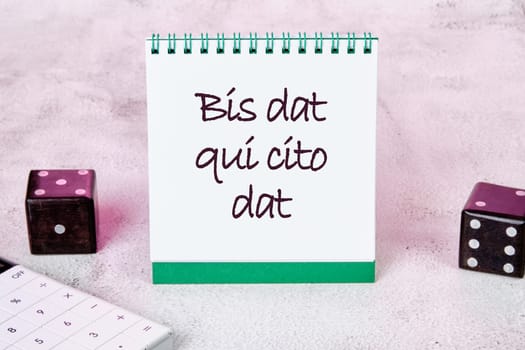 Bis dat qui cito dat It is translated from Latin as The one who gives twice is the one who gives quickly It is written on a white sheet of a notebook