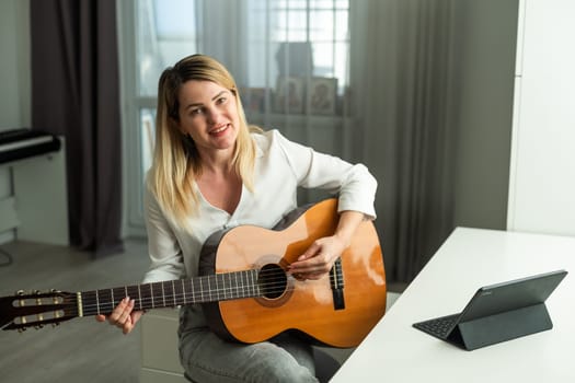 woman holding a guitar with her hands. High quality photo