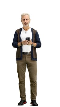 A man, full-length, on a white background, uses a phone.