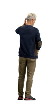 A man, full-length, on a white background, clutched his head.