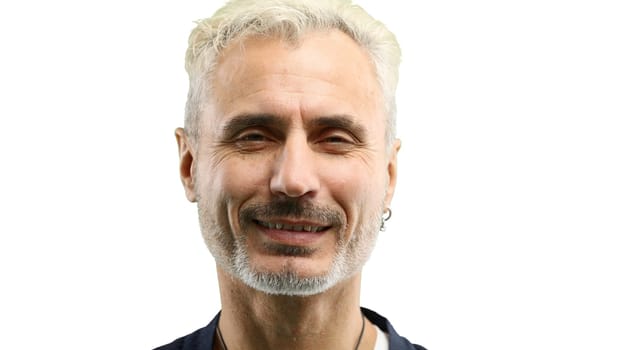 Man's face, in close-up, on a white background.