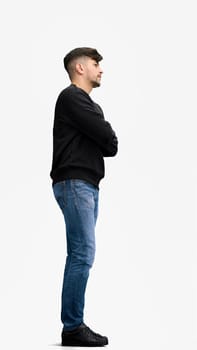 A man, full-length, on a white background, crossed arms.