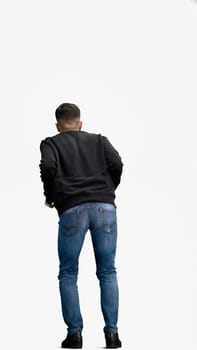 A man, full-length, on a white background, rubs his hands.