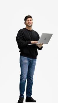 A man, full-length, on a white background, uses a phone.