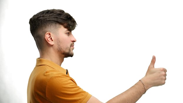 A man, close-up, on a white background, shows his thumbs up.