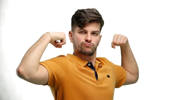 Man, close-up, on a white background, shows strength.