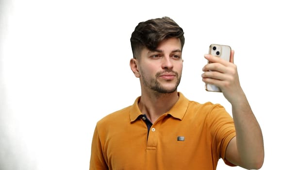 Man, close-up, on a white background, talking on the phone.