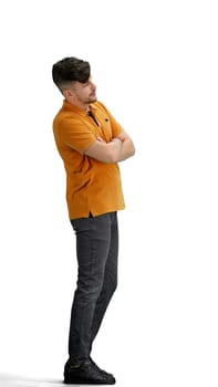 A man, full-length, on a white background, crossed his arms.
