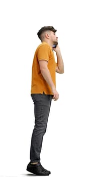A man, full-length, on a white background, talking on the phone.