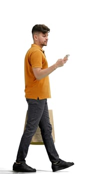A man, full-length, on a white background, with bags and a phone.