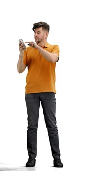 A man, full-length, on a white background, with bags and a phone.