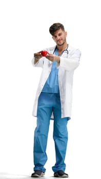 The doctor, in full height, on a white background, shows the heart.