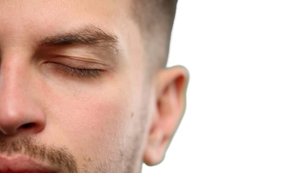 Man's face, close-up, on a white background.