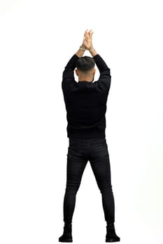 A man, full-length, on a white background, spreads his arms.