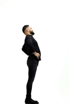 Man, full-length, on a white background, hands on hips.