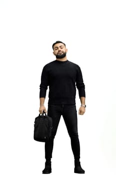 A man, full-length, on a white background, with a briefcase.