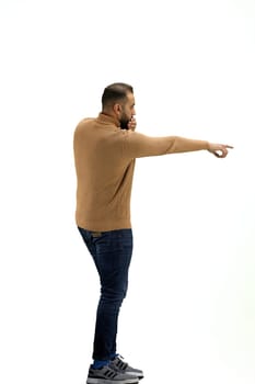 A man, full-length, on a white background, raised his hand up.