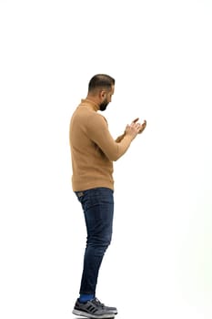 A man, full-length, on a white background, claps.
