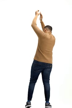 A man, full-length, on a white background, claps.