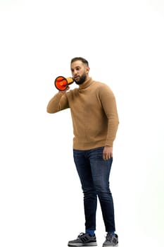 A man, full-length, on a white background, with a megaphone.