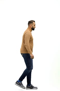 A man, full-length, on a white background, is walking.