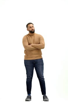A man, full-length, on a white background, crossed his arms.