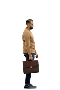 A man, full-length, on a white background, with a briefcase.