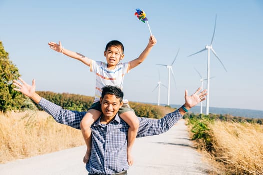 Dad carrying daughter with pinwheel smiling. Family joy near windmills represents global innovation in renewable energy. A moment of bonding joy and happiness in the community. Father Day