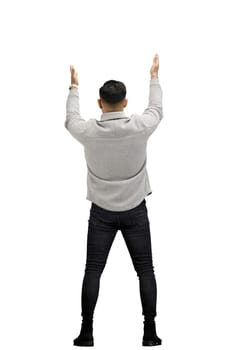A man, full-length, on a white background, spreads his arms.
