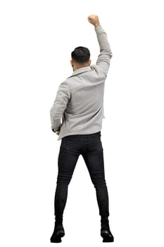 A man, full-length, on a white background, raised his hand up.