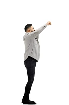 A man, full-length, on a white background, rejoices.