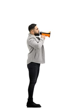 A man, full-length, on a white background, with a megaphone.