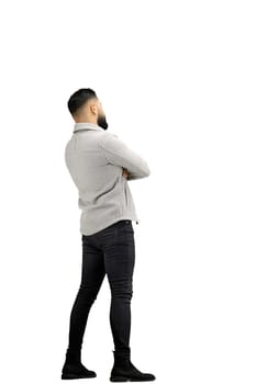 A man, full-length, on a white background, crossed his arms.