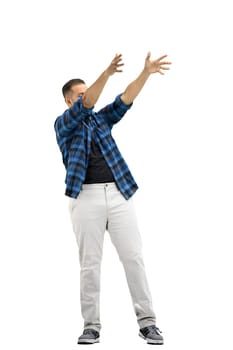 A man, full-length, on a white background, raised his hands up.