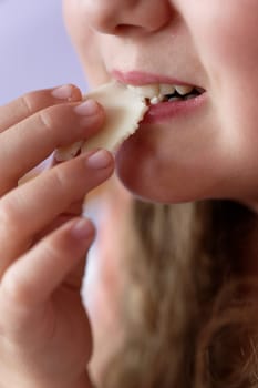 Young girl - child eating candy and sweets. Detail of face and mouth. Concept for healthy lifestyle - healthy - unhealthy sweet food and sugar.