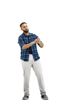 A man, full-length, on a white background, claps.