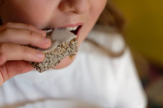 Young girl - child eating candy and sweets. Detail of face and mouth. Concept for healthy lifestyle - healthy - unhealthy sweet food and sugar.